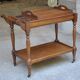 Serving table with a tray, on wheels, made of solid exotic wood.
