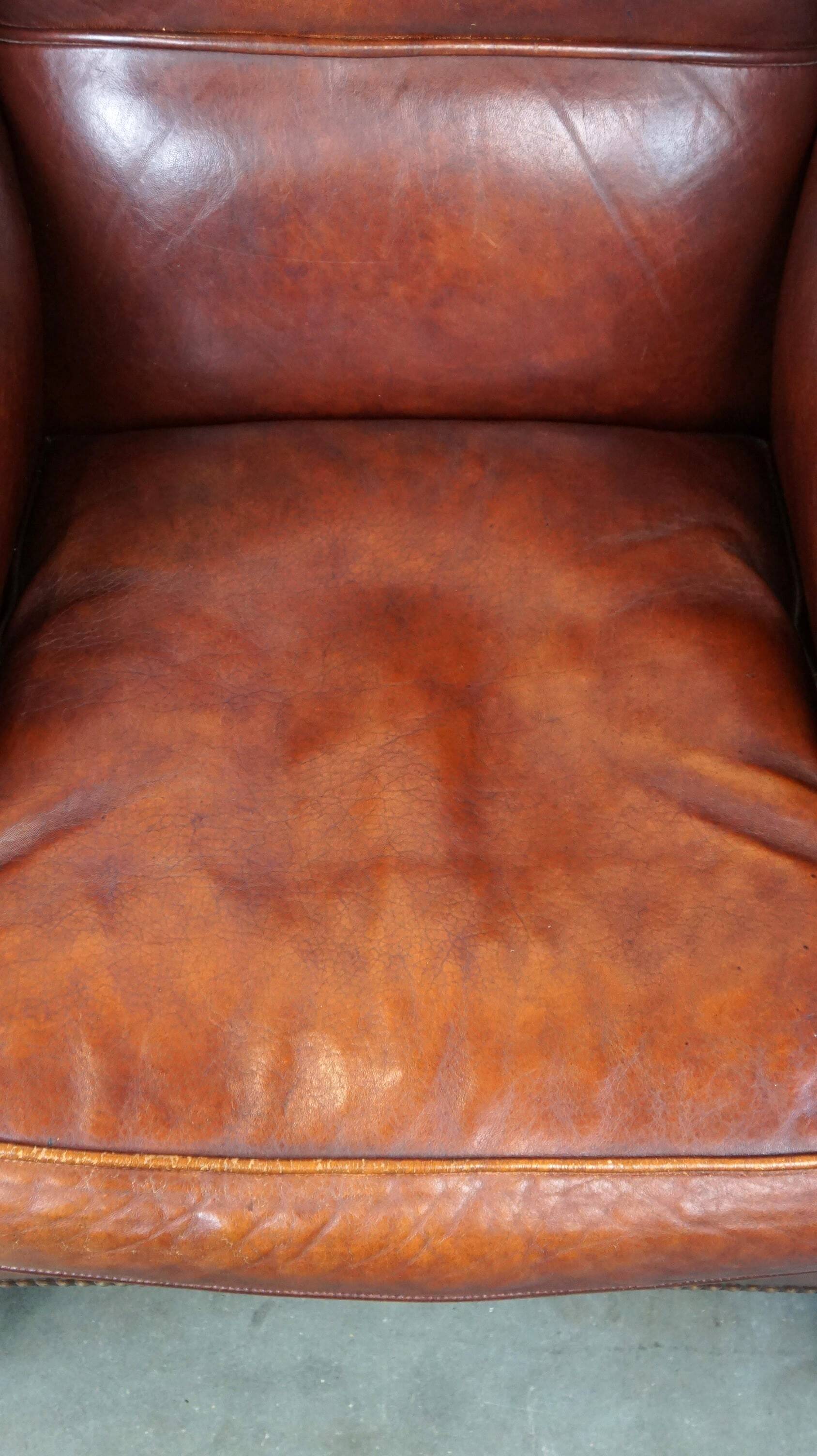 Large comfortable sheepleather wingchair in good condition and beautiful colours