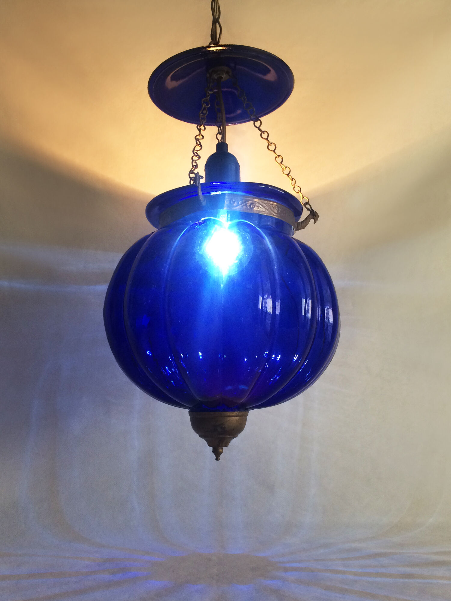 Suspension chandelier, oriental blue glass lantern and brass structure. Year 70-80