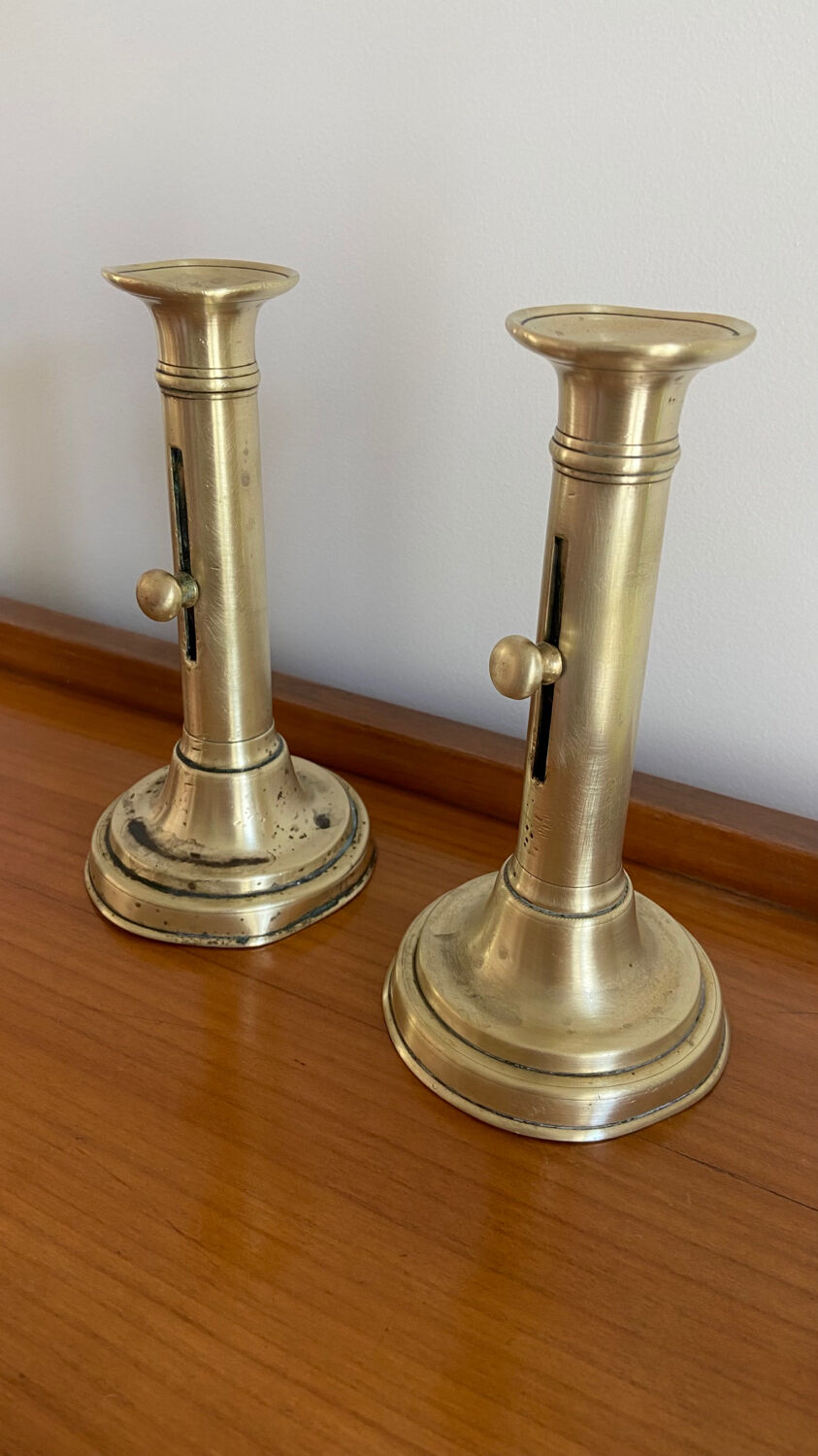 Pair of antique brass push candlesticks