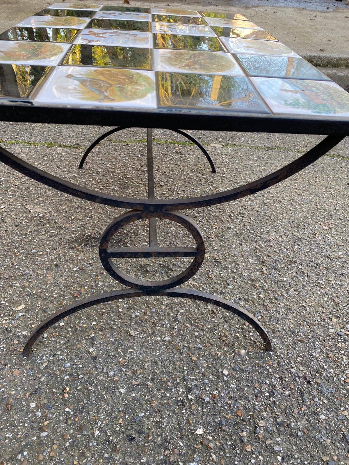 Vintage coffee table with black wrought iron and white tiles.