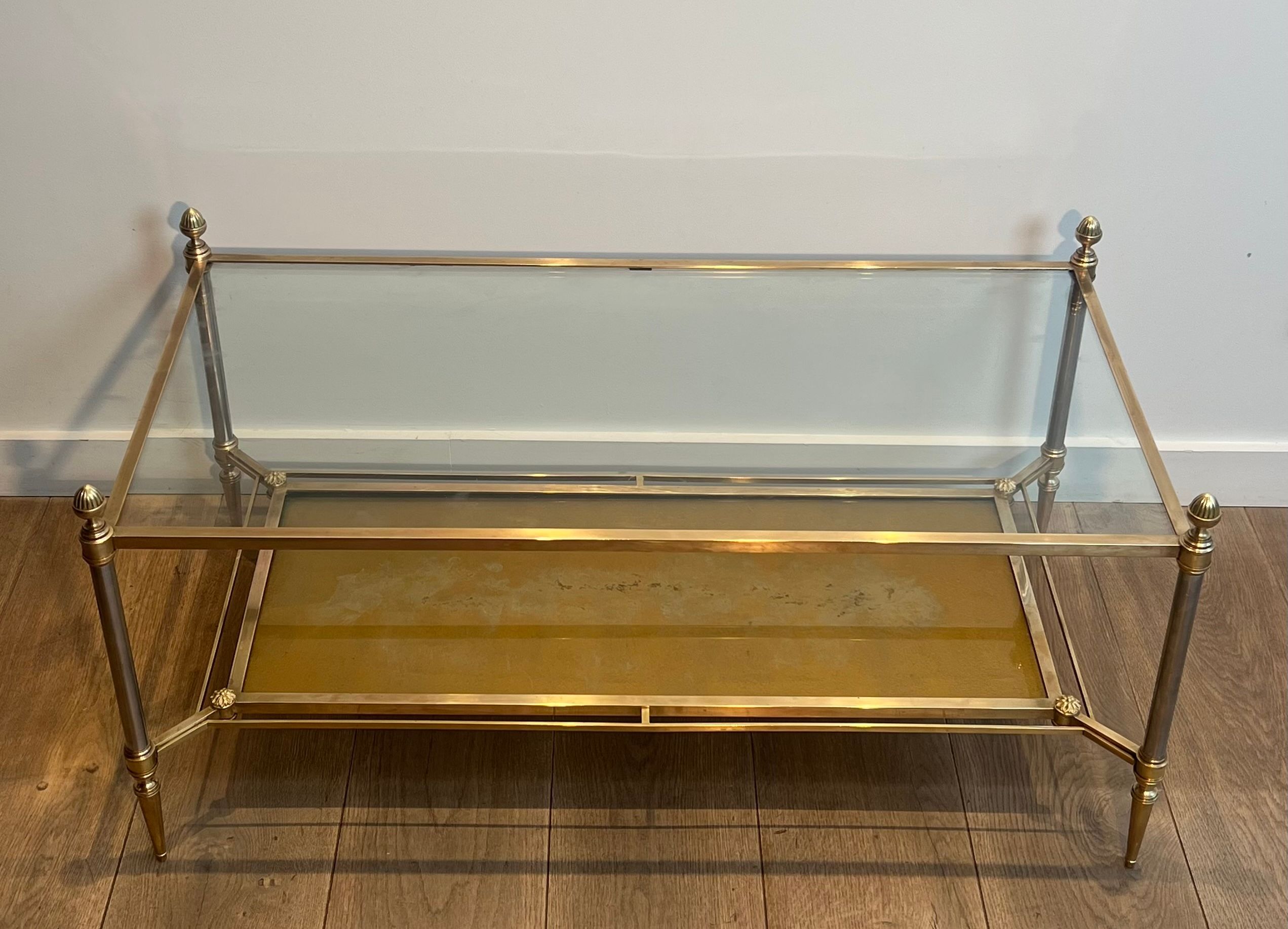 Coffee table in brass, brushed steel, glass, and gilded eglomisé mirror from Maison Jansen.