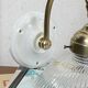 Swan neck wall light in brass with a ribbed glass shade, Holophane type.