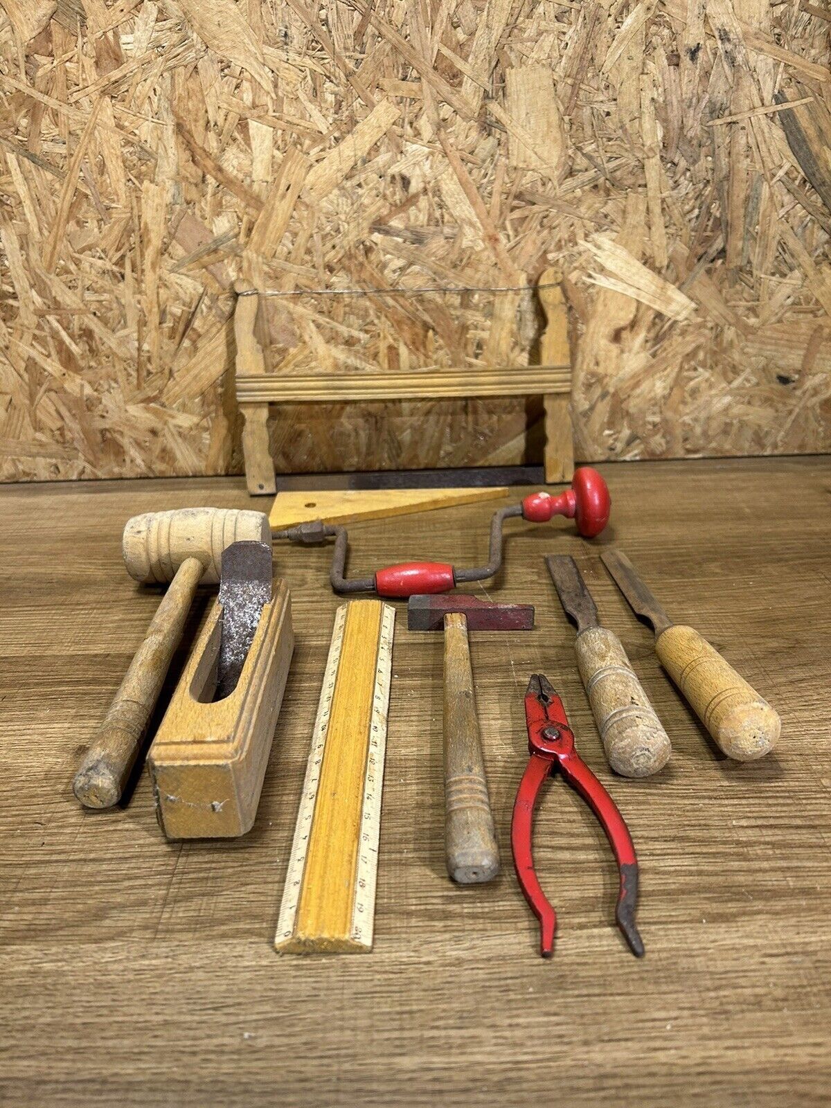 lot of antique toys, carpentry tools, wood, saw, plane, hammer,...