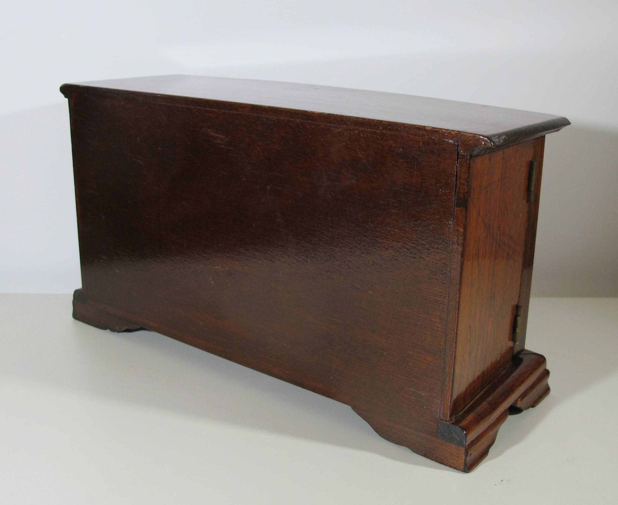 Wooden jewelry box in the shape of a dresser