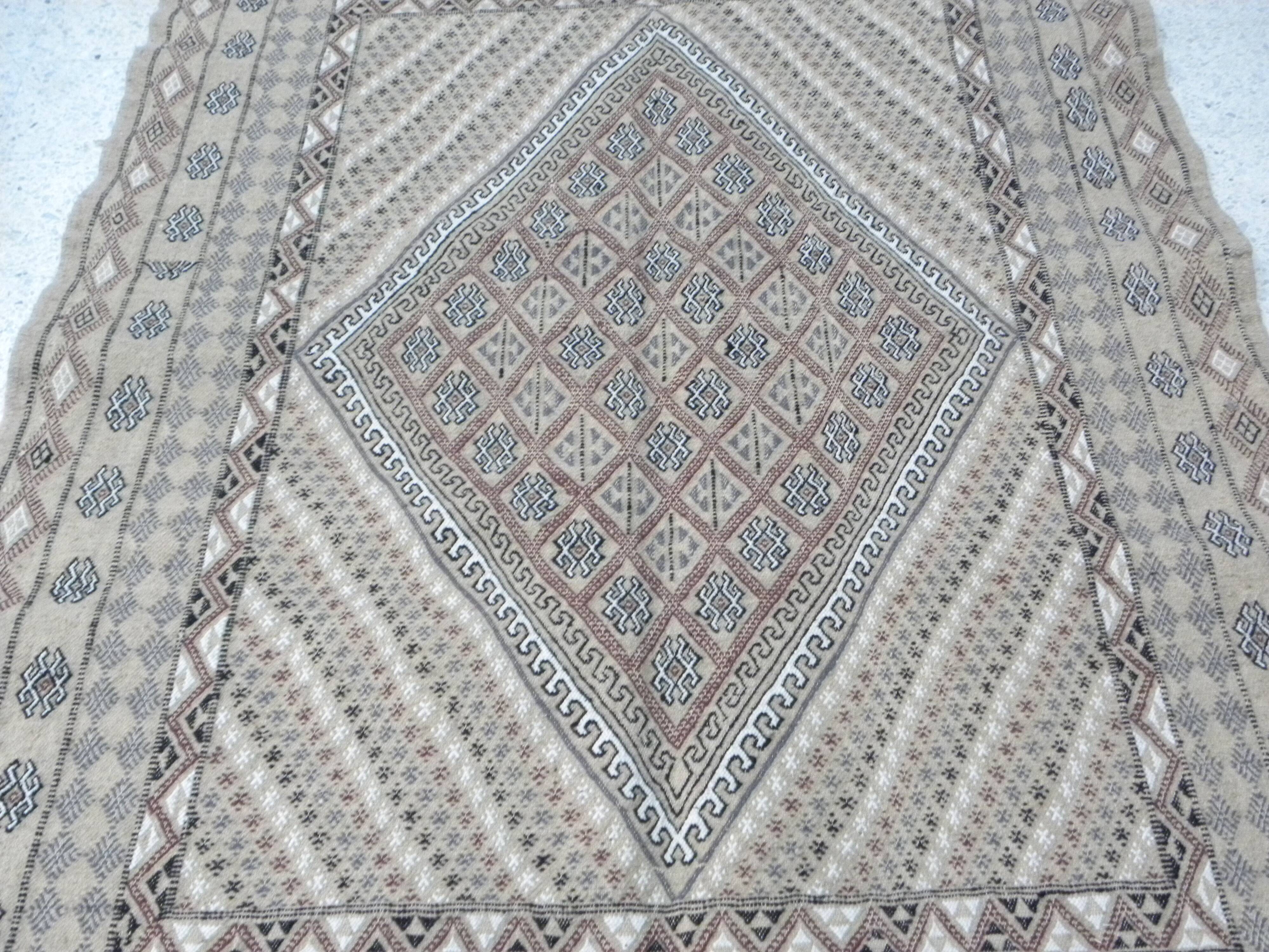 Traditional handmade Berber carpet in brown and beige wool.