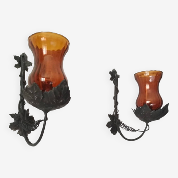 Pair of black wrought iron wall lights decorated with vine leaves and orange glass tulips