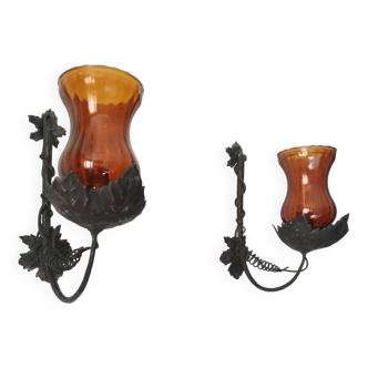 Pair of black wrought iron wall lights decorated with vine leaves and orange glass tulips