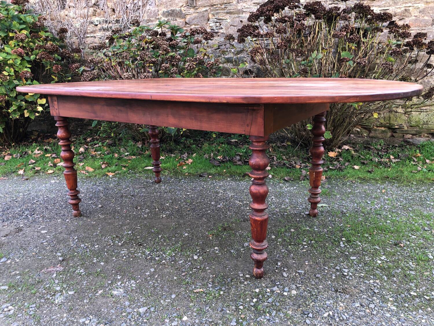 Antique cherry wood farmhouse table with rounded ends