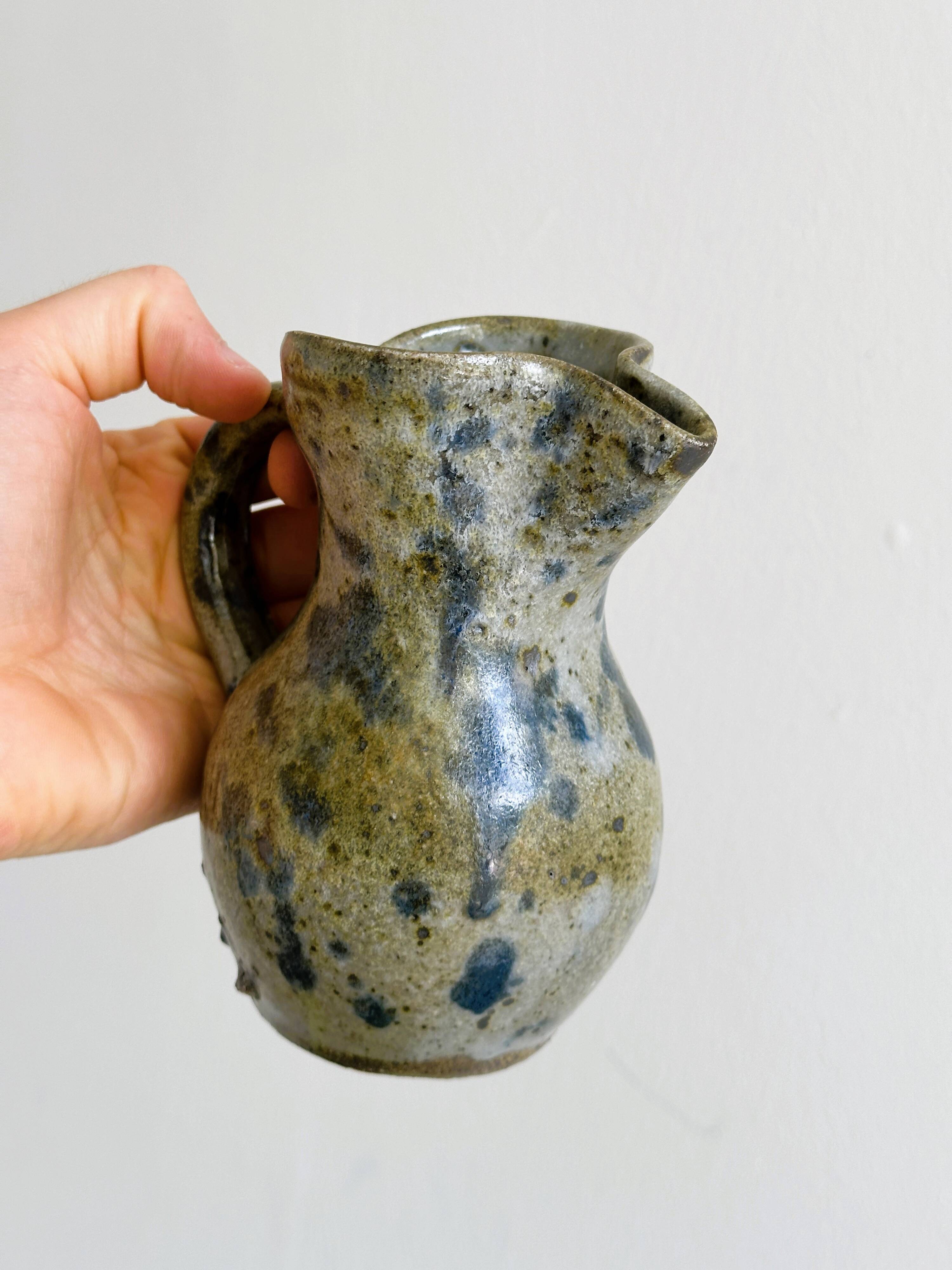 Small handcrafted ceramic pitcher with spotted enamel