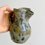 Small handcrafted ceramic pitcher with spotted enamel