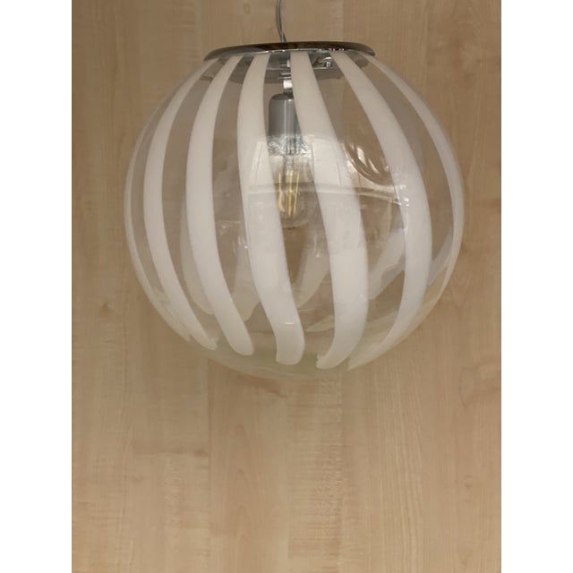 Contemporary transparent and white sphere pendant in murano glass