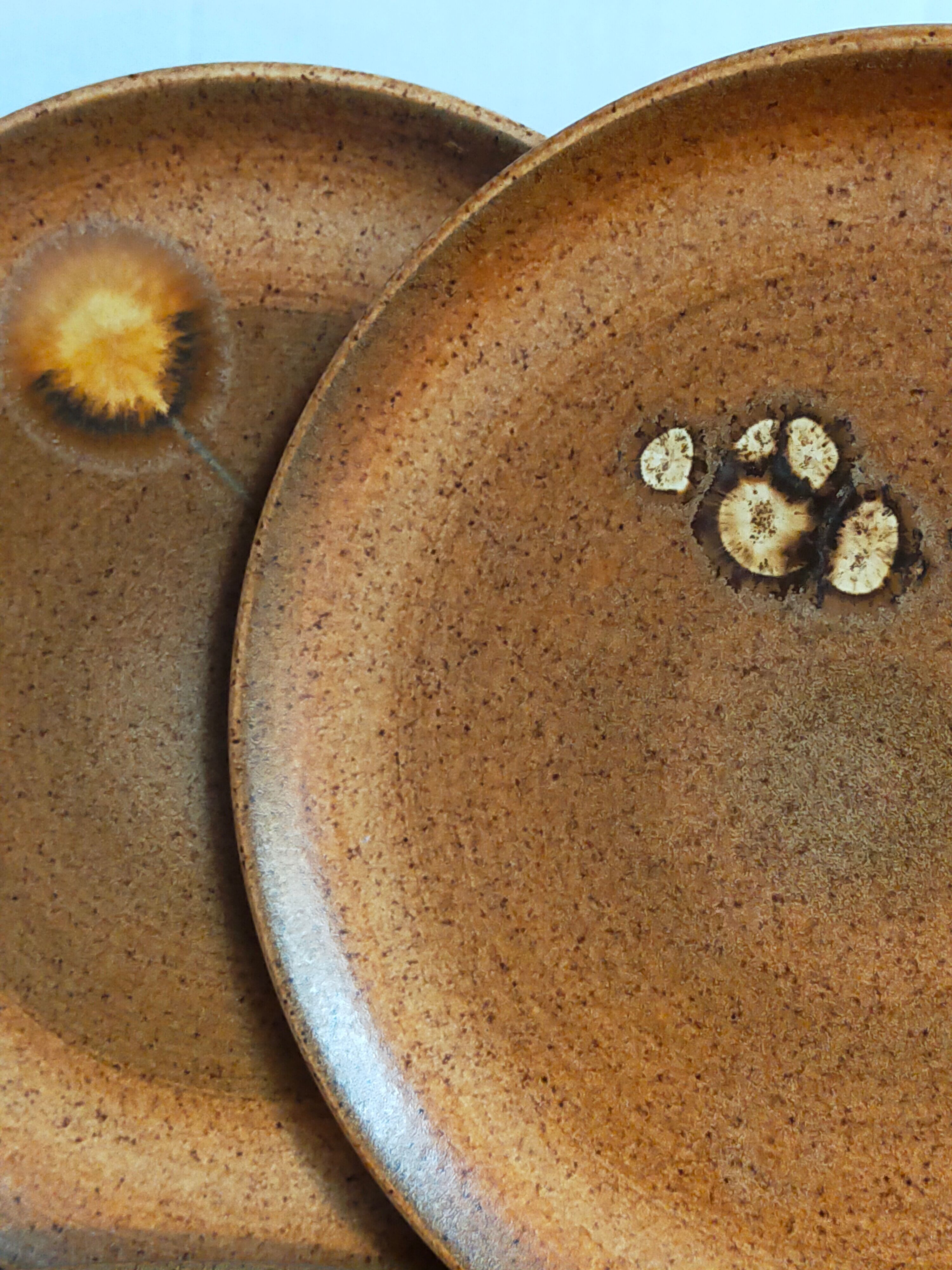 Four vintage glazed stoneware potter's plates