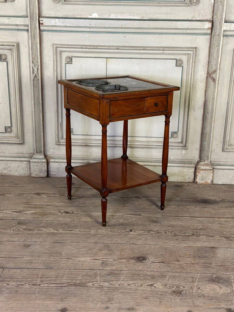 Refreshment table in mahogany, grey marble top, two zinc buckets, 18th century.