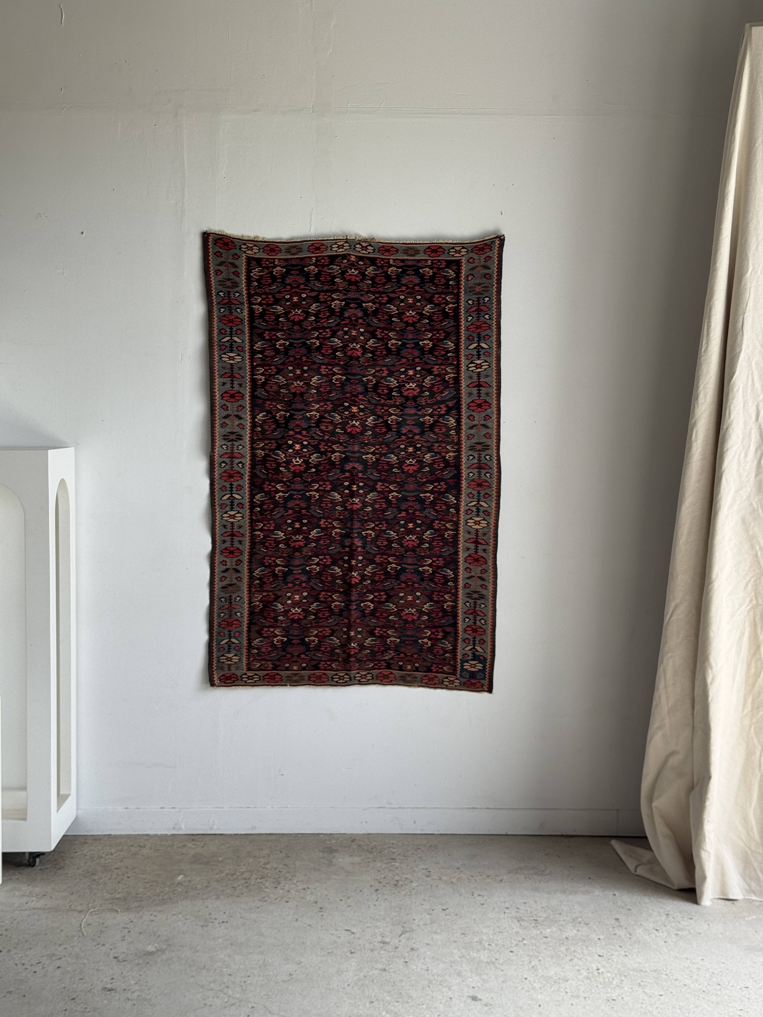 Iranian rug with stylised floral patterns in pink and blue, 155x105.