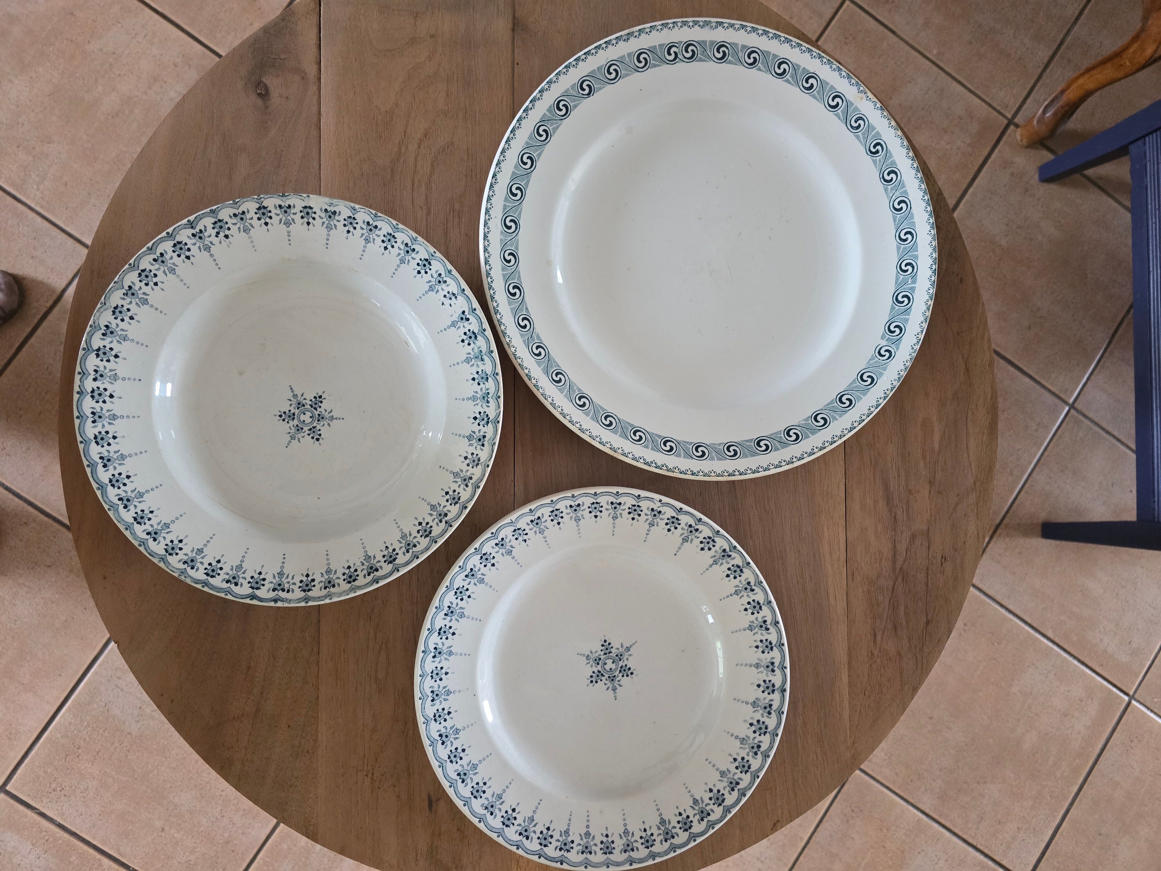 Old green-blue faience plates and dishes with geometric patterns.