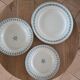 Old green-blue faience plates and dishes with geometric patterns.