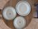 Old green-blue faience plates and dishes with geometric patterns.