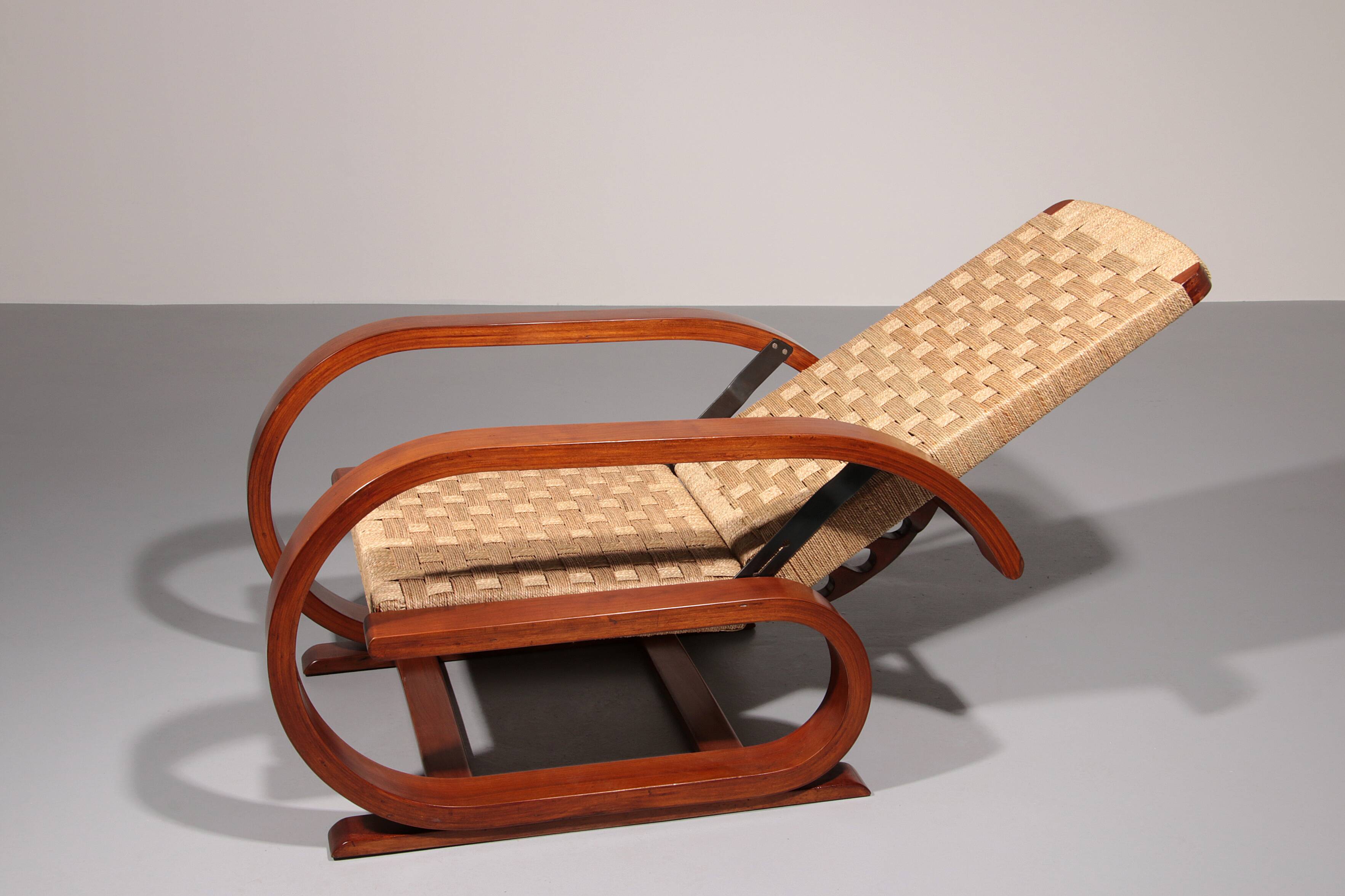 An exceptionally rare mahogany recliner crafted in Italy during the 1950s"