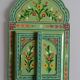Mirror under shutters with painted flower decoration