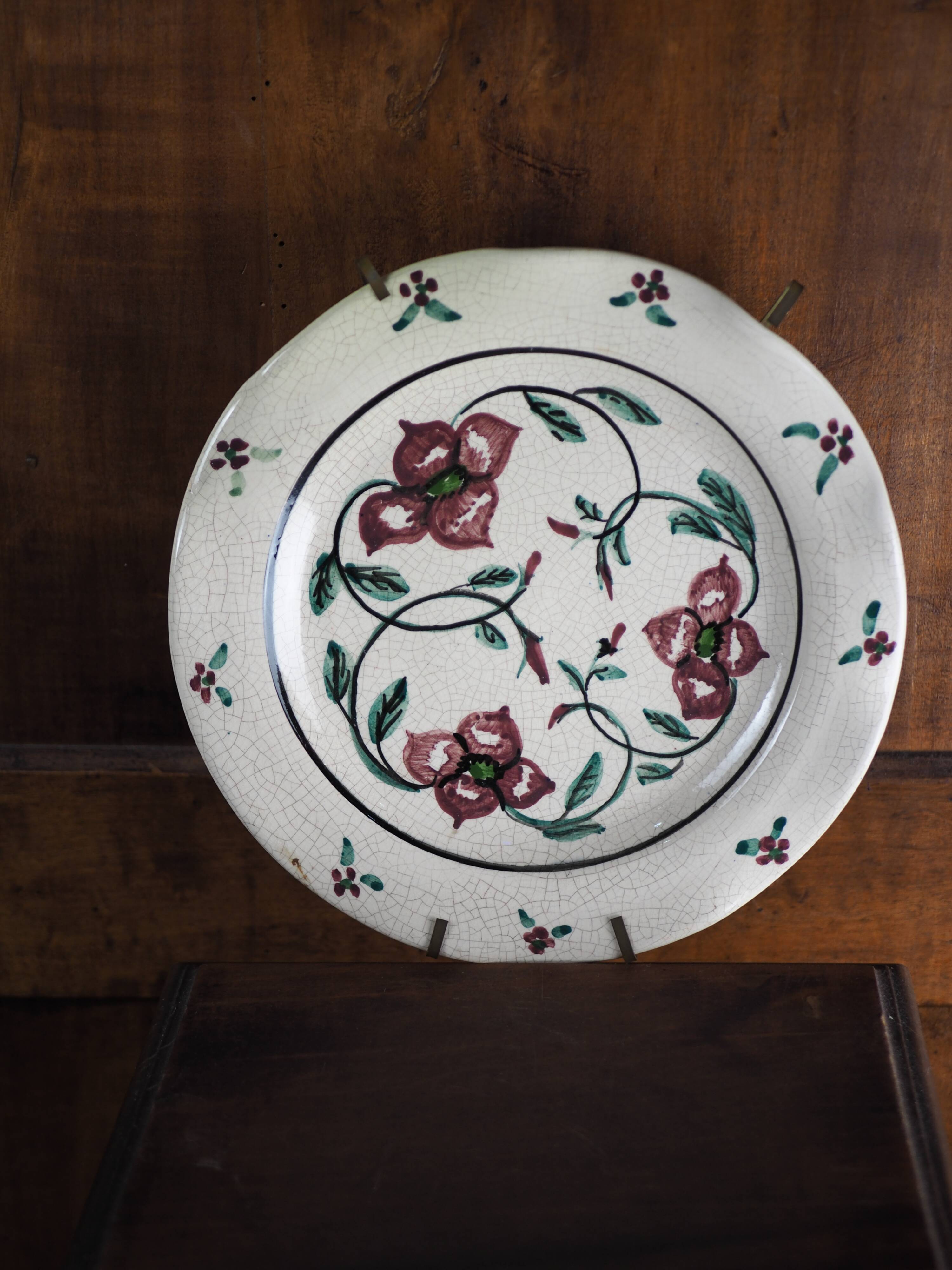 Meyssac plate decorated with flowers on cracked background early twentieth century and its support