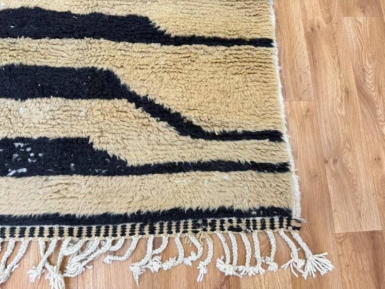 Handmade Moroccan rug in ecru with coloured patterns, 250cm x 150cm.