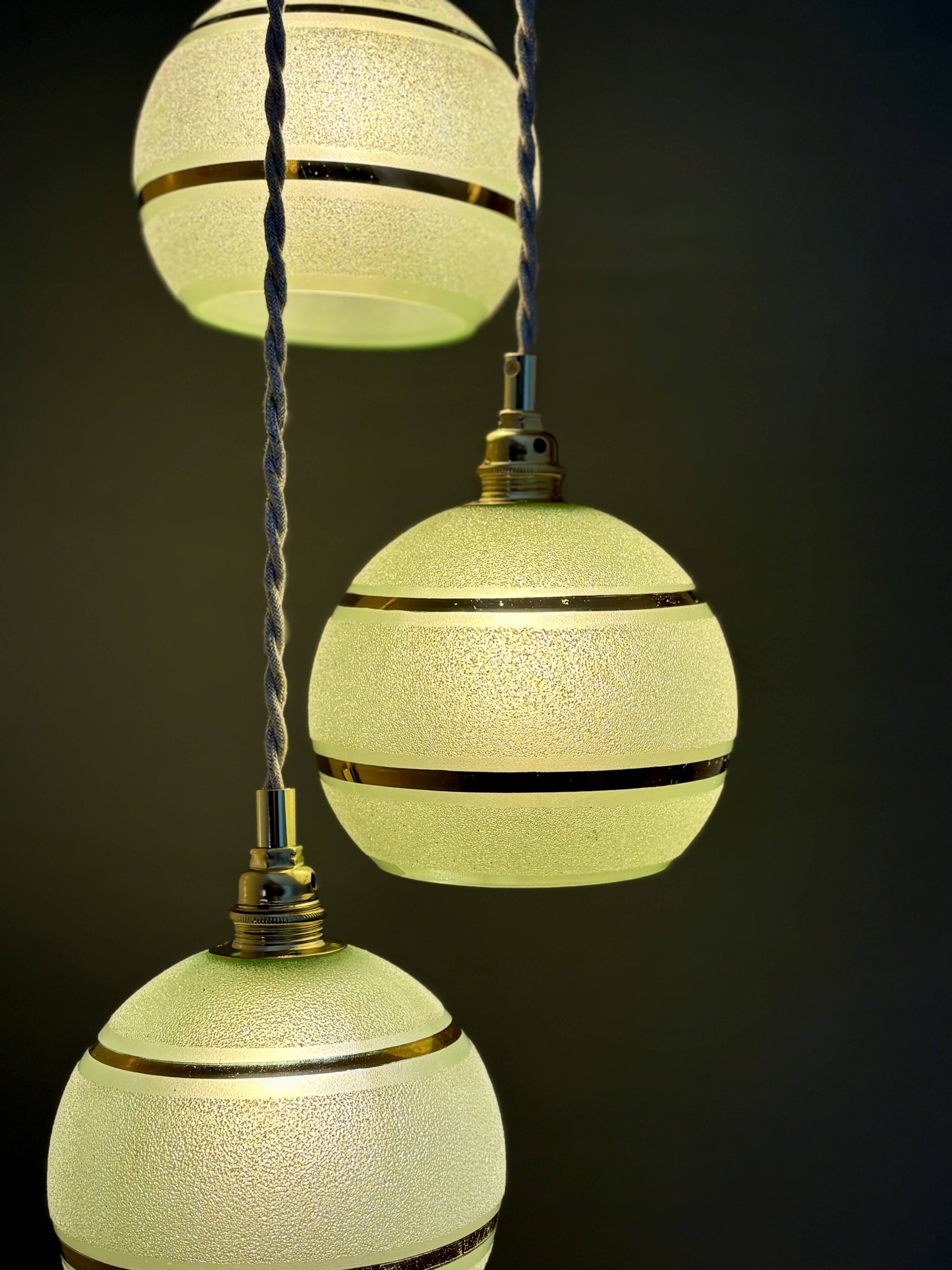 Suspension triple vintage glass globes in frosted green and gold.