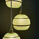Suspension triple vintage glass globes in frosted green and gold.