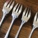 8 mismatched fish forks, silver metal