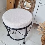 Black iron stool/pouf with its boucle fabric cushion.