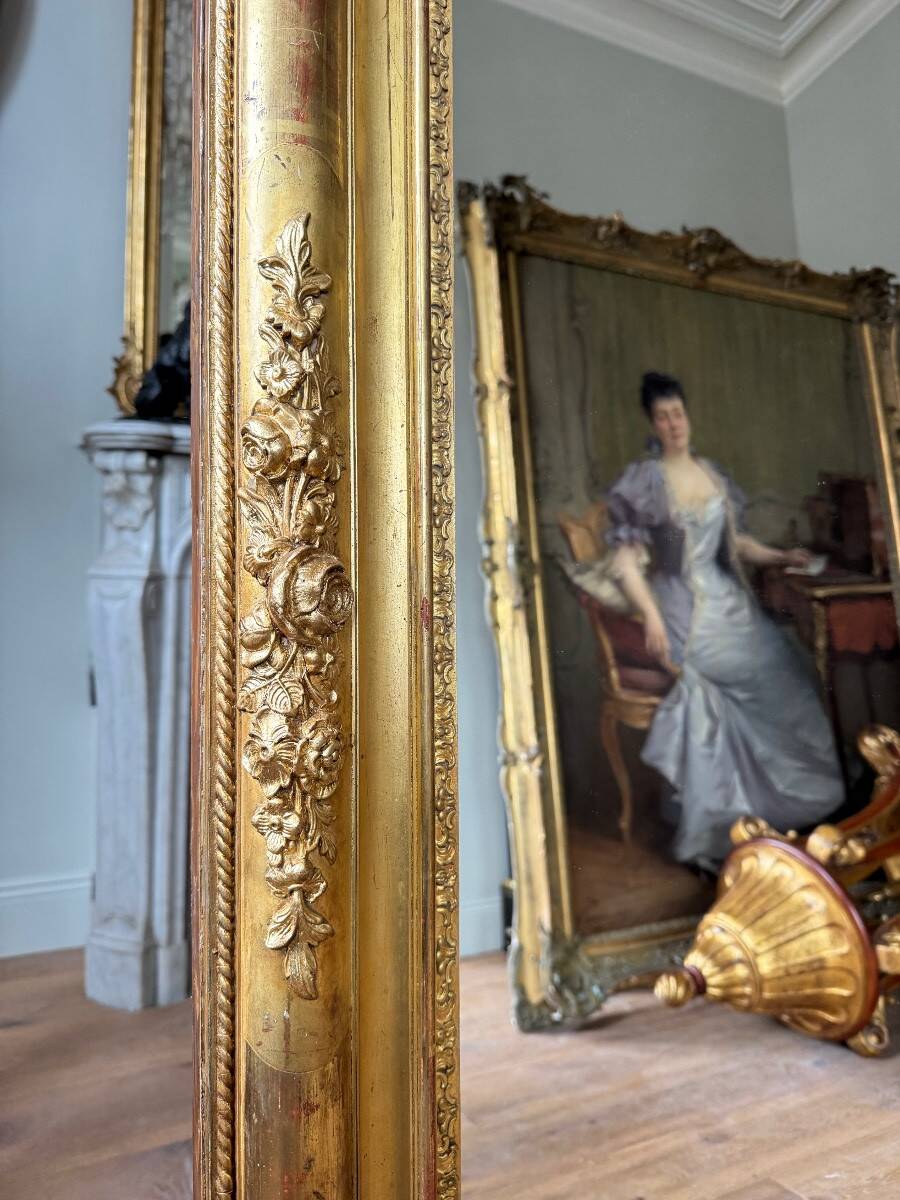 Restoration period mirror in gilded wood from the Napoleonic III era, 165 cm x 130 cm.