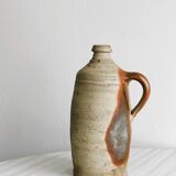 Old rustic stoneware bottle with handle
