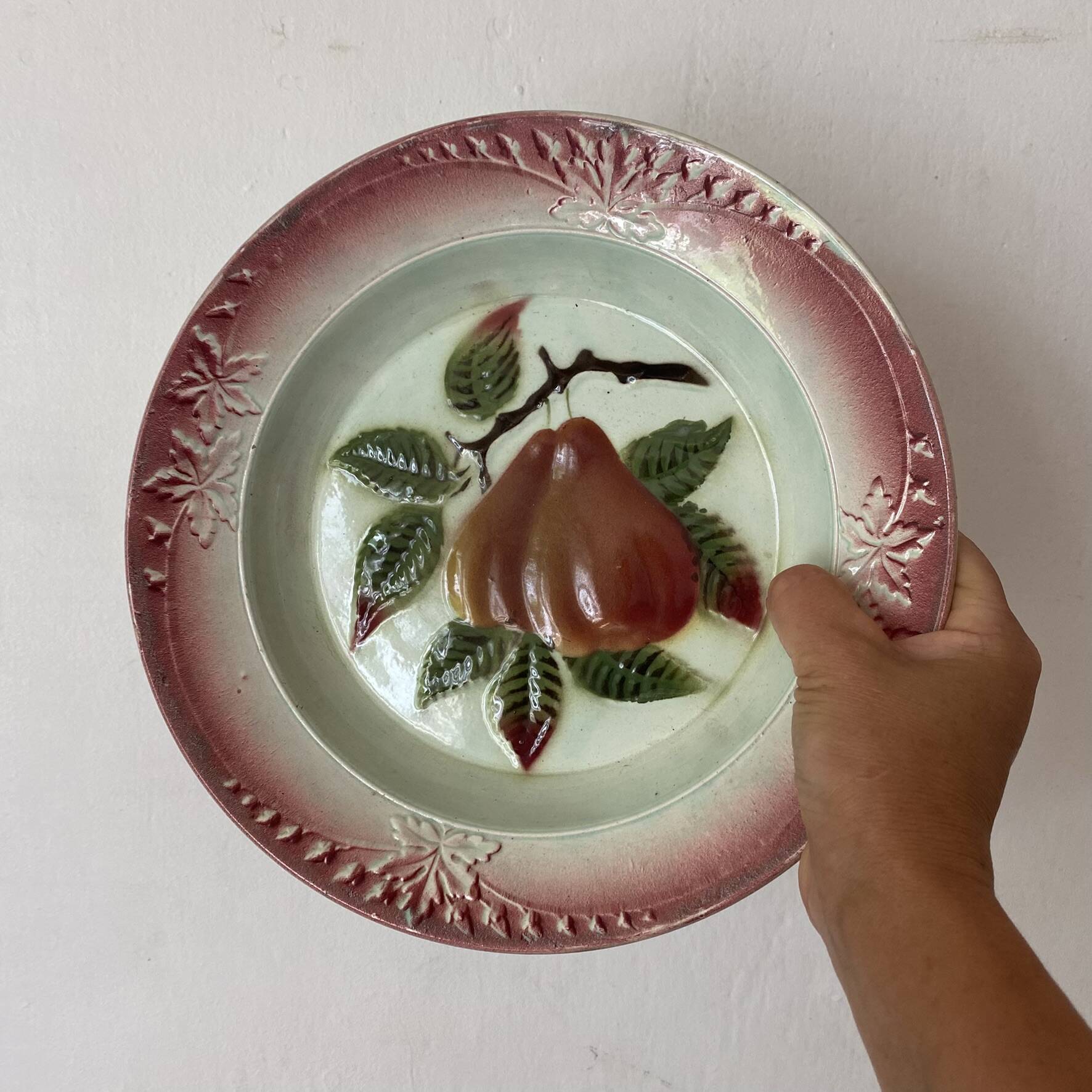 Antique shallow dish in slipware with pear decoration.
