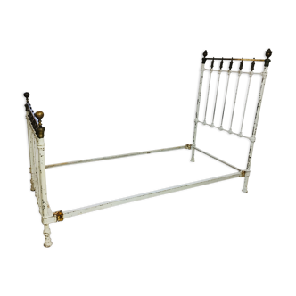 Old white metal and brass bed