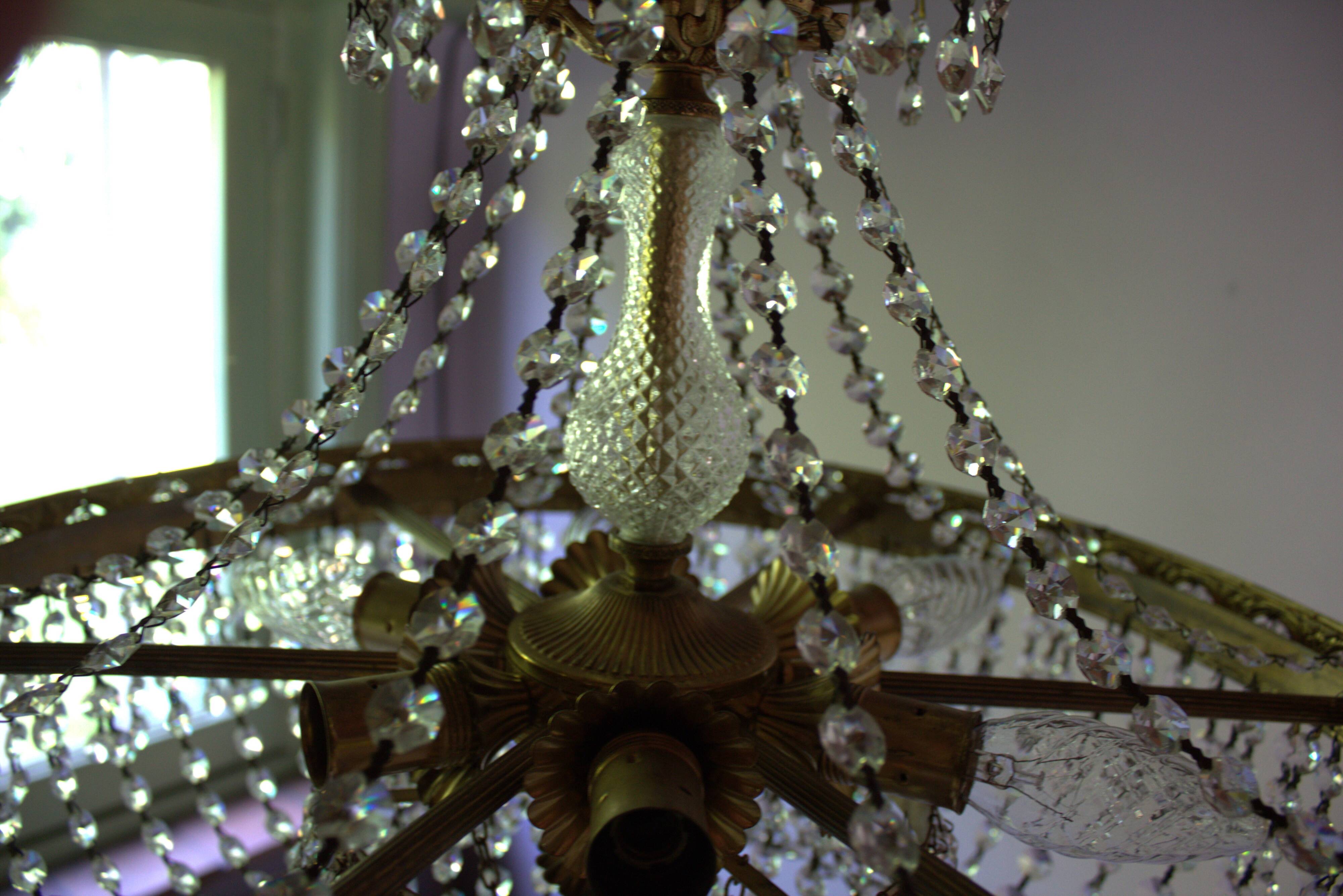 Antique castle style chandelier with tassels and floral details