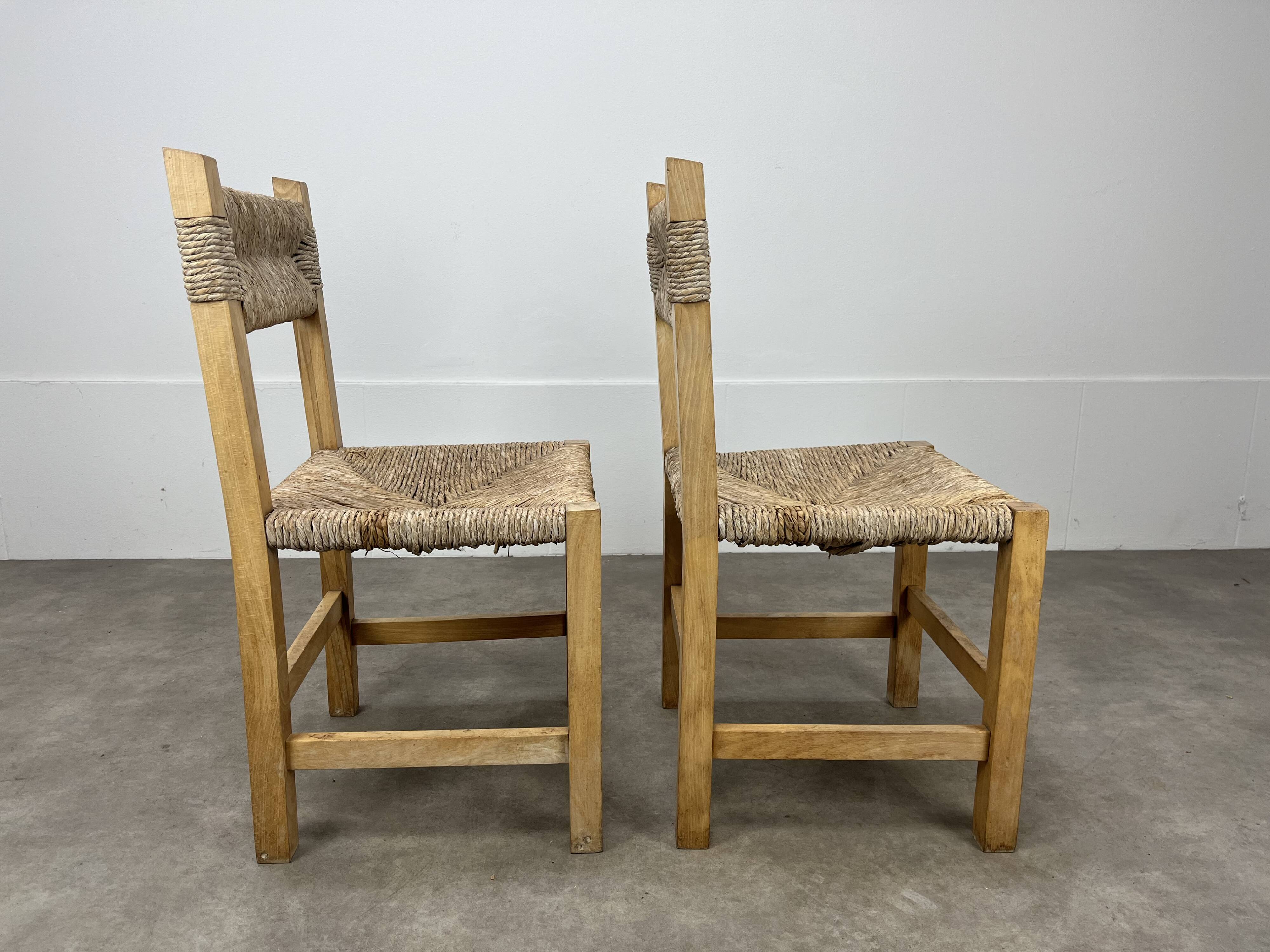 2 straw and wood chairs in brutalist style