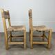 2 straw and wood chairs in brutalist style