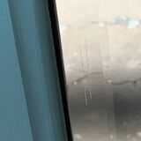 Beveled mirror on turquoise Parisian door