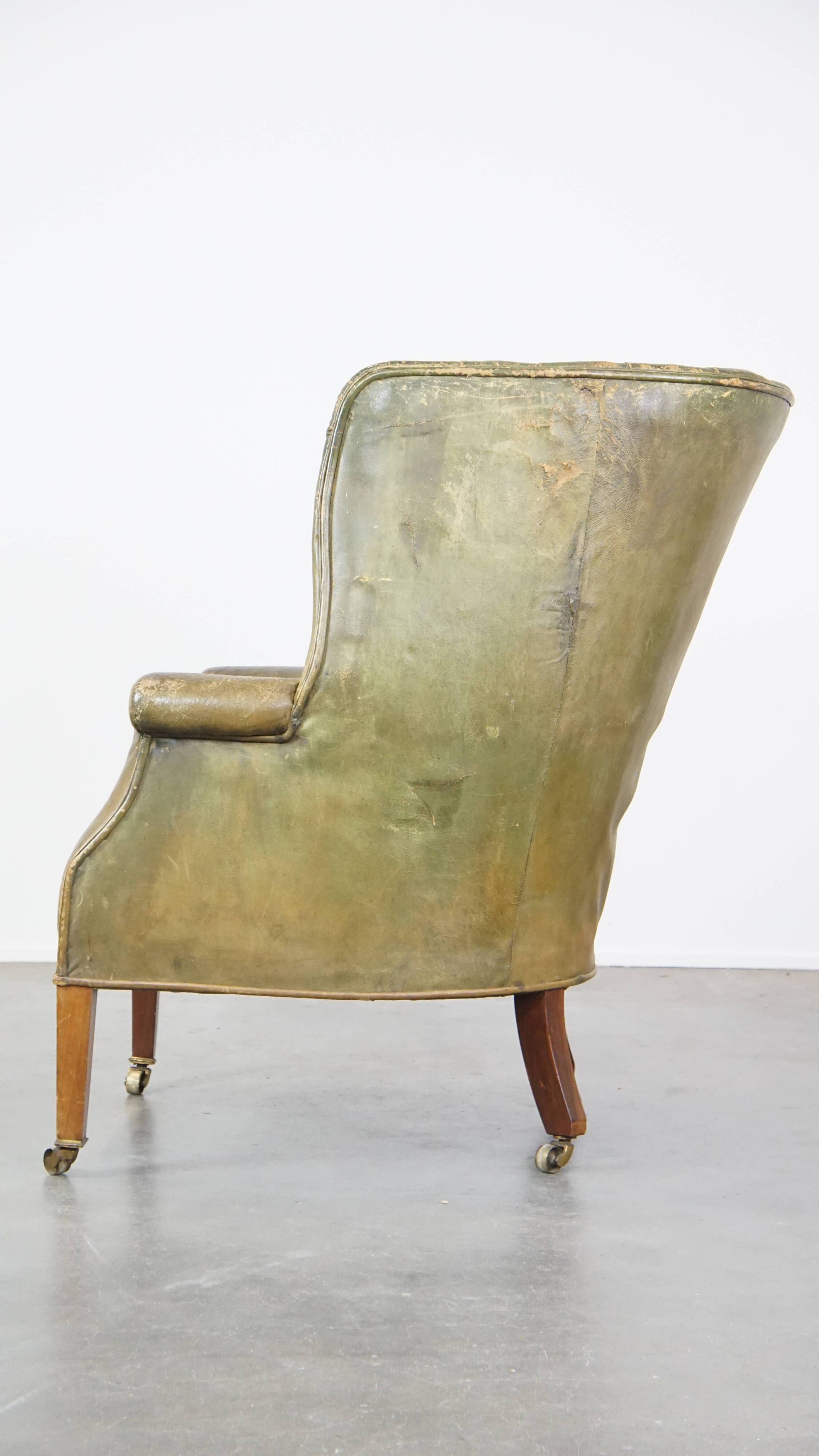 Green antique barrel back wingback chair on wheels
