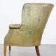 Green antique barrel back wingback chair on wheels