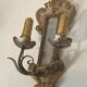 Pair of wall sconces in carved wood and silvered and gilded patinated metal with a central mirror.