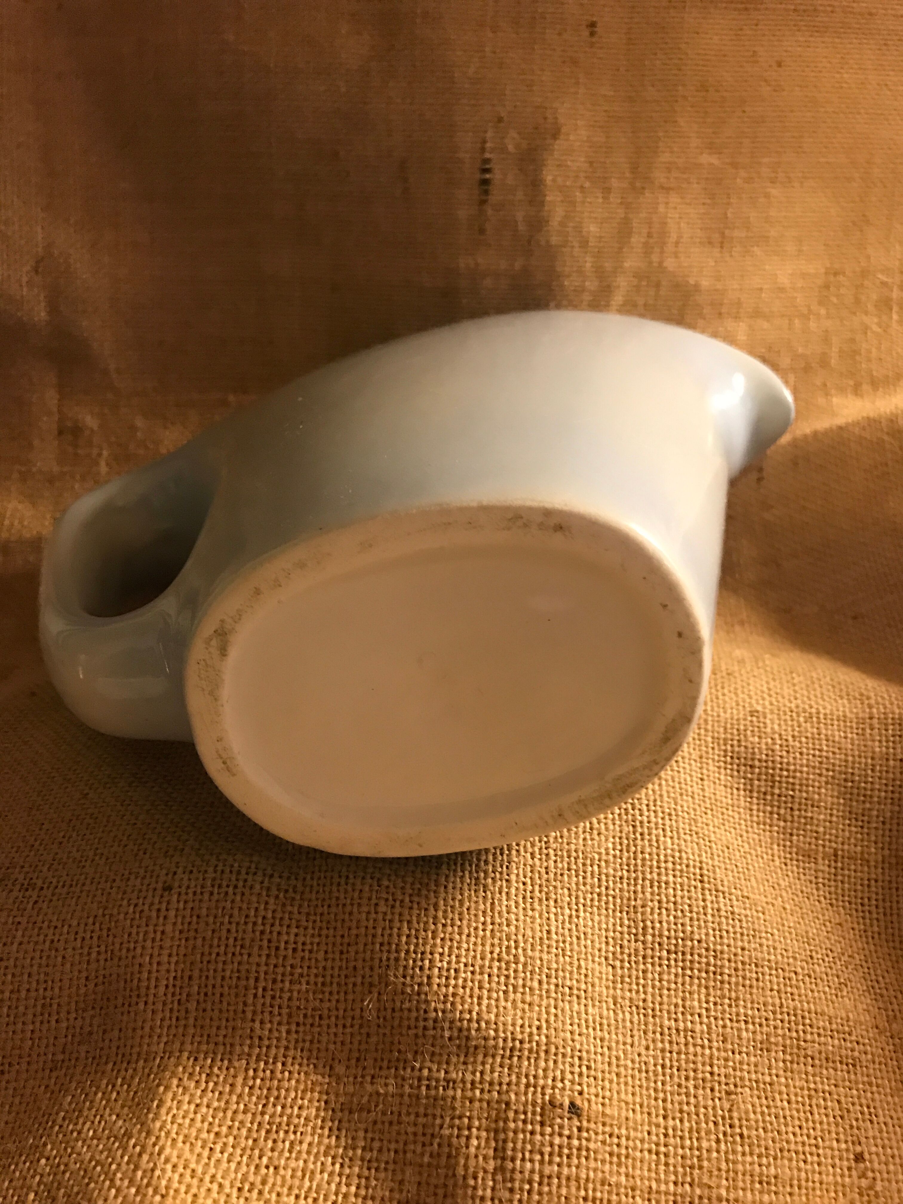 Light blue pitcher in vintage earthenware