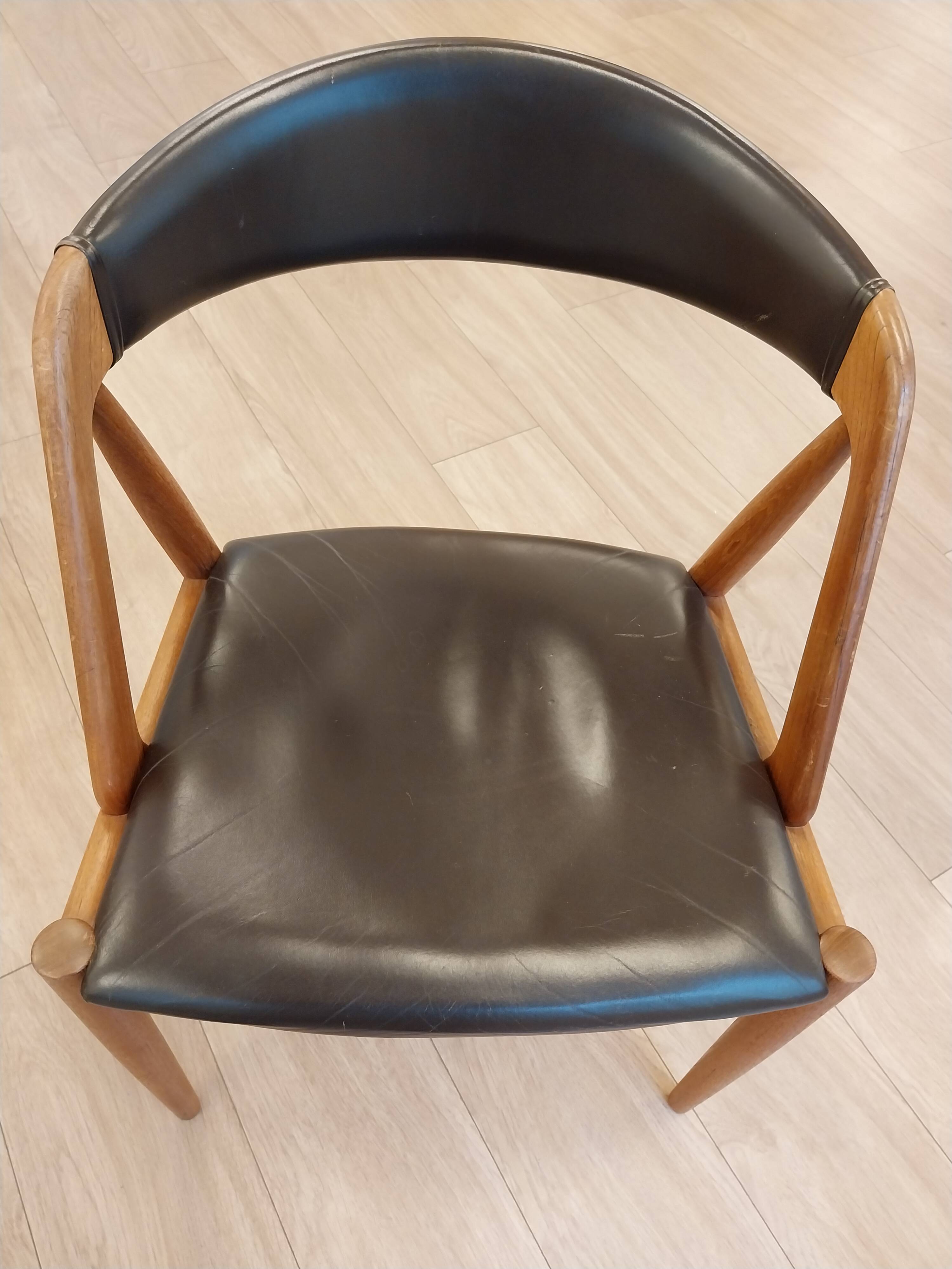 Set of 6 vintage Kai Kristiansen chairs in solid teak and black faux leather.