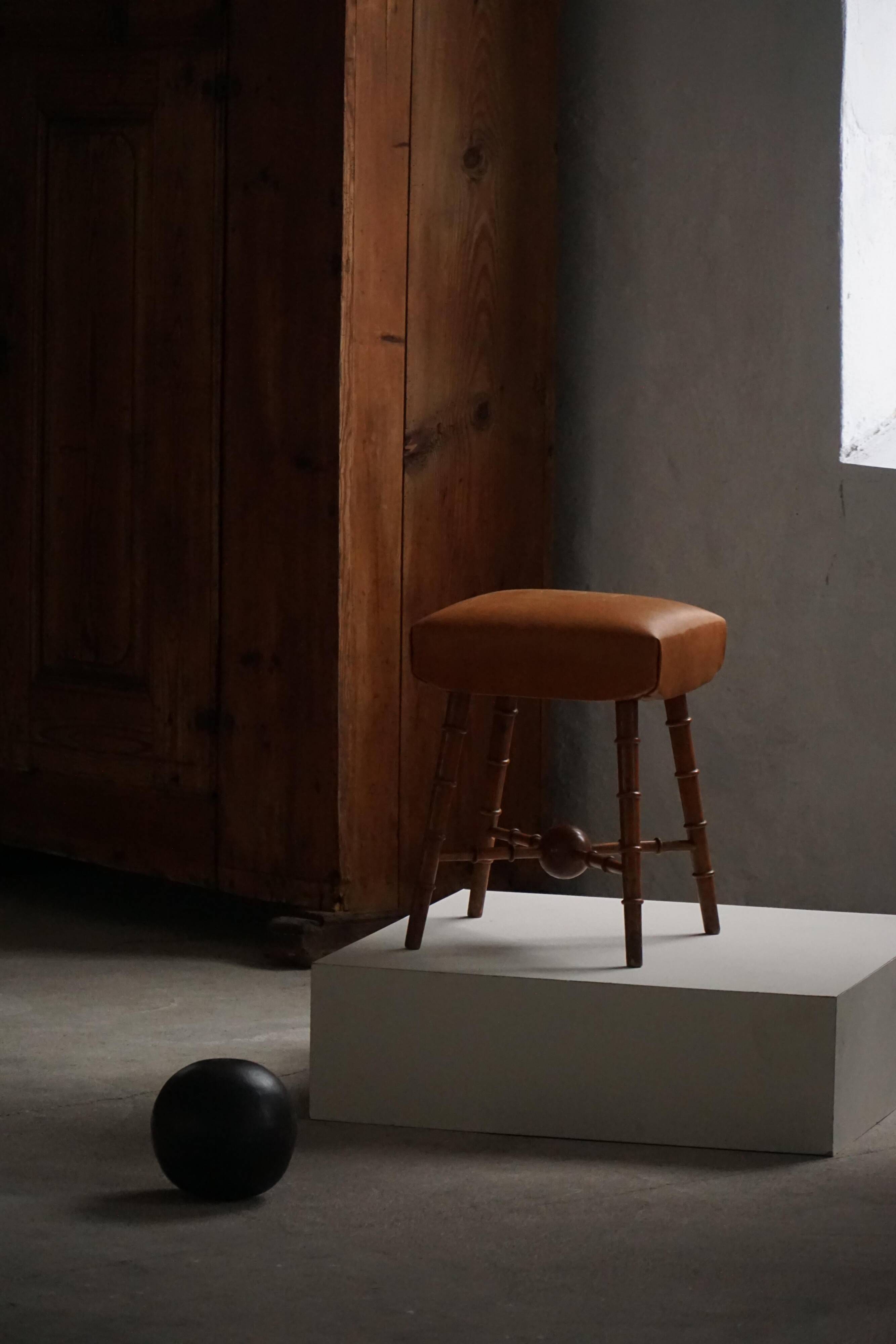 Turned wooden stool with leather seat, mid-20th century, Danish modern.