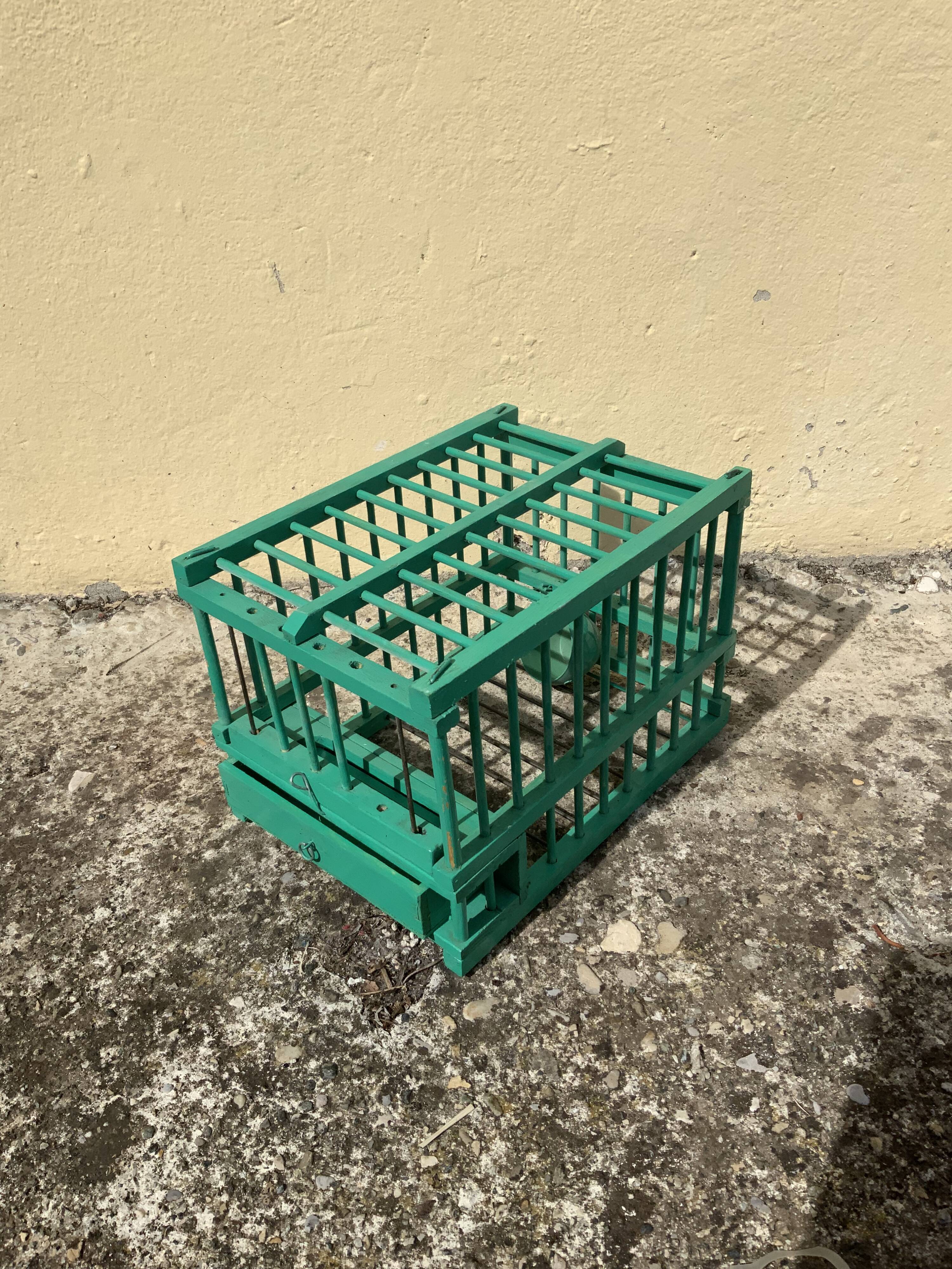 Vintage bird cage in green wood retro paint