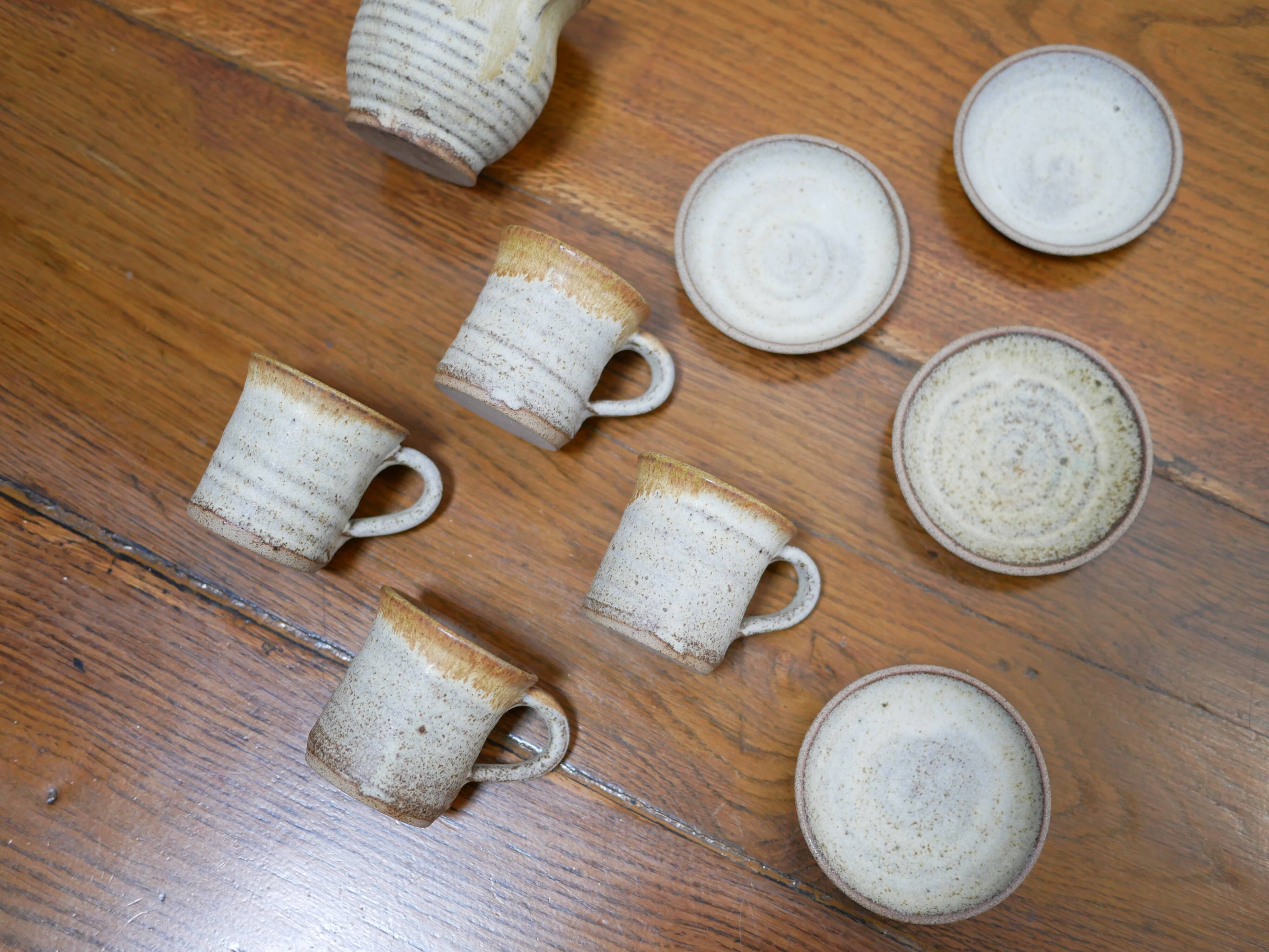 Series of 4 cups and a vintage stoneware milk jug