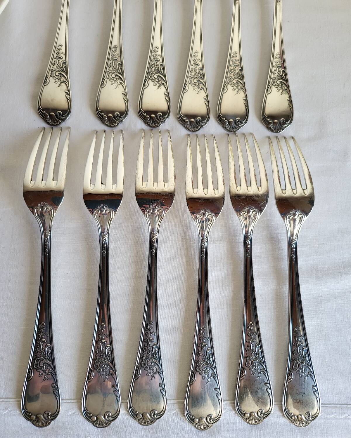 12 large silver-plated metal table forks by Guildart
