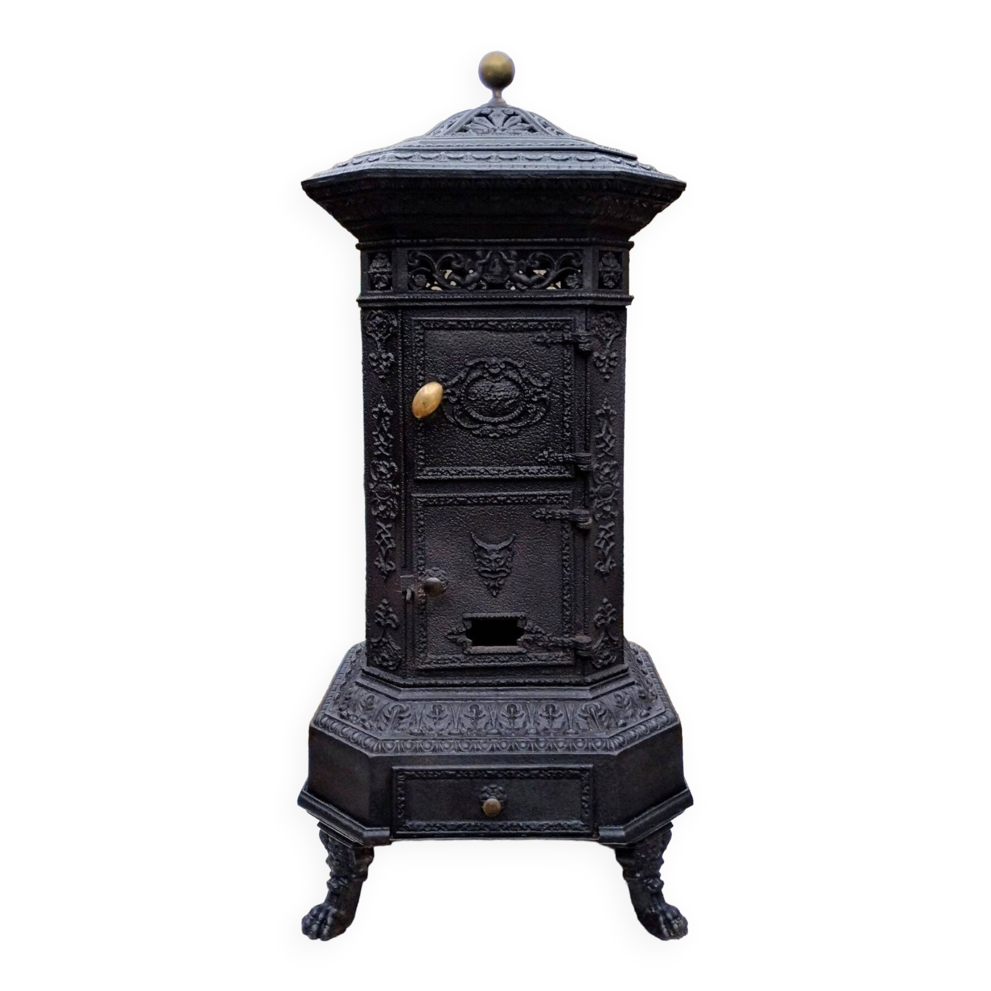 Black cast iron wood burning stove with solid brass handle.
