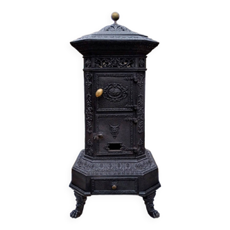 Black cast iron wood burning stove with solid brass handle.