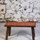 Brutalist coffee table in orange ceramic and solid wood.